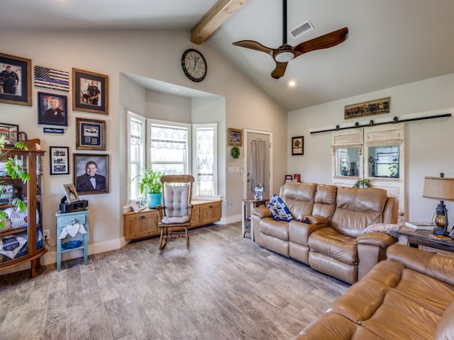 living room with high vaulted ceiling, a barn door, light hardwood / wood-style flooring, ceiling fan, and beamed ceiling