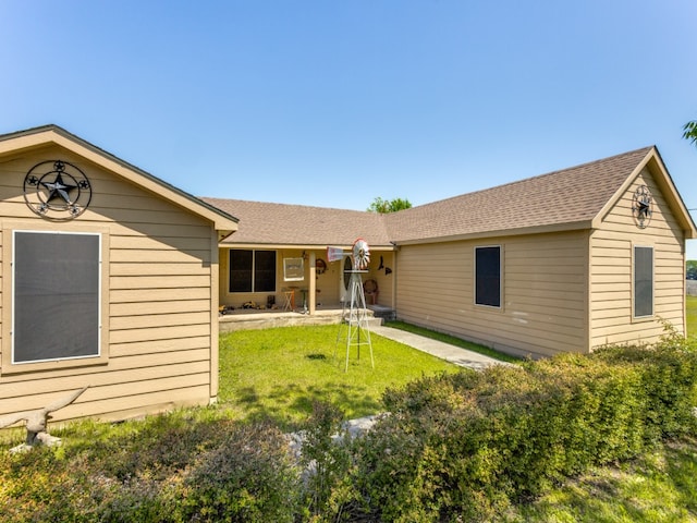 rear view of house with a lawn