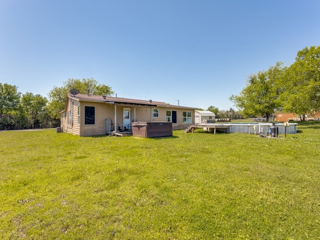 rear view of property with a yard