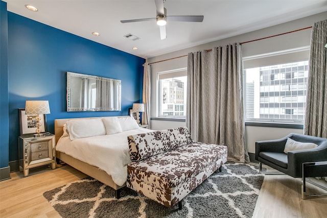 bedroom with a ceiling fan, wood finished floors, recessed lighting, and visible vents