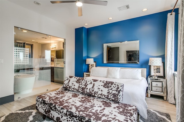 bedroom with light wood-style flooring, recessed lighting, ensuite bathroom, and visible vents