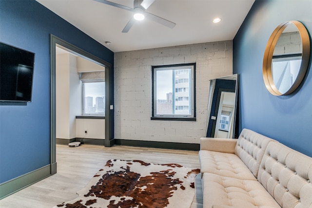 living room featuring ceiling fan and light wood-type flooring