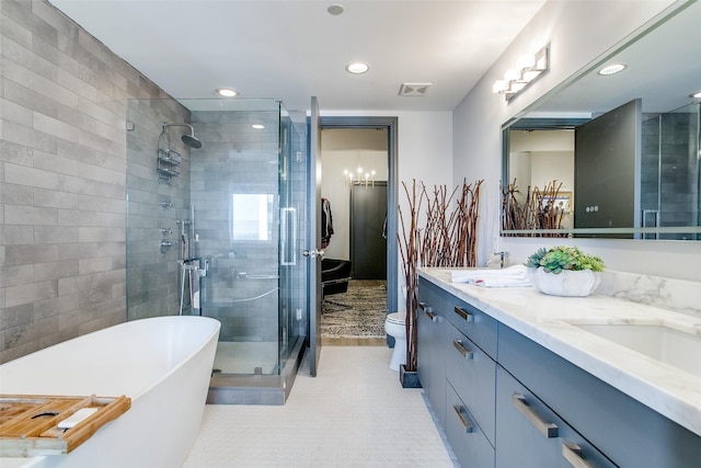 full bath featuring a stall shower, a soaking tub, double vanity, visible vents, and recessed lighting