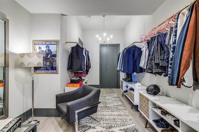 mudroom with light hardwood / wood-style flooring and a chandelier