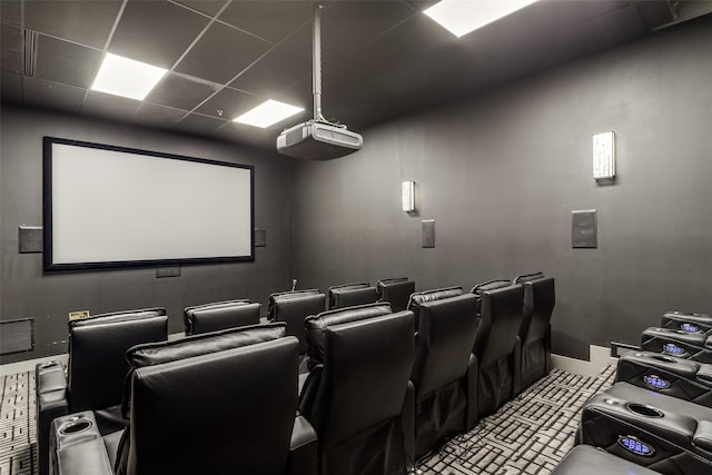 cinema room featuring a drop ceiling