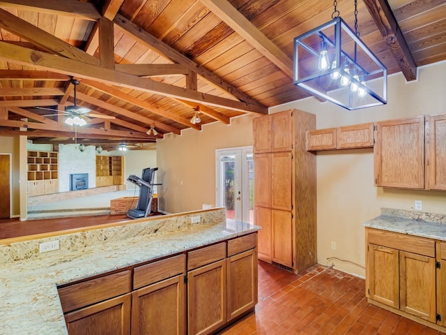 kitchen featuring vaulted ceiling with beams, a large fireplace, ceiling fan, wood ceiling, and hanging light fixtures