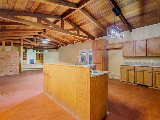 kitchen with brick wall, ceiling fan, wood ceiling, beam ceiling, and decorative light fixtures