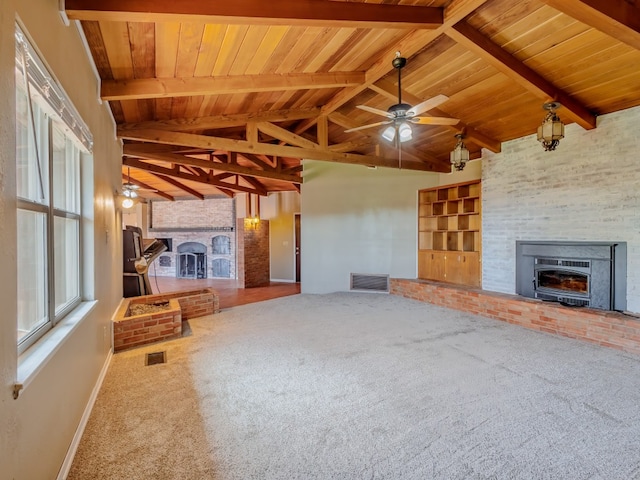 unfurnished living room featuring light carpet, a brick fireplace, wood ceiling, and ceiling fan