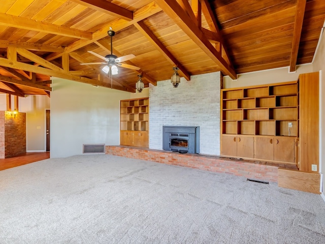 unfurnished living room with carpet, a brick fireplace, ceiling fan, wood ceiling, and built in shelves