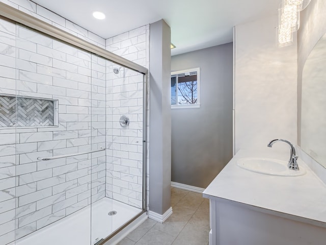 bathroom with vanity, a shower with door, and tile flooring