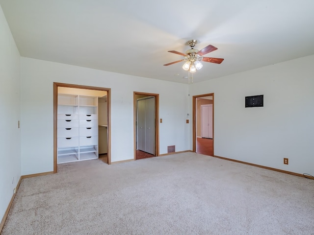 unfurnished bedroom with light colored carpet and ceiling fan