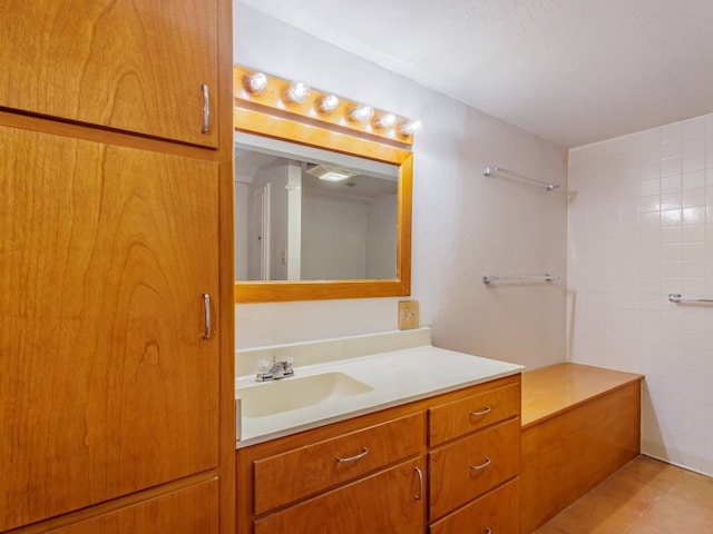 bathroom with tile floors and vanity