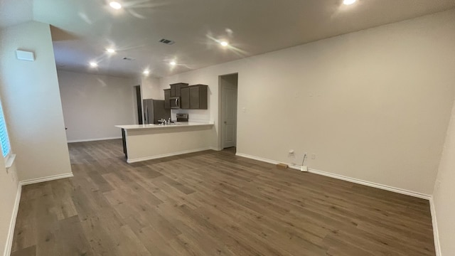 unfurnished living room featuring dark wood-type flooring