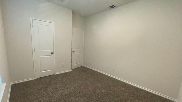 unfurnished bedroom featuring dark colored carpet