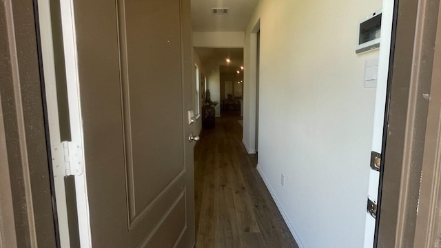 corridor with dark hardwood / wood-style floors