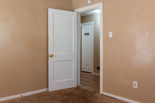 spare room featuring light carpet