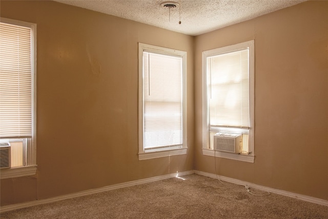 carpeted spare room featuring a textured ceiling