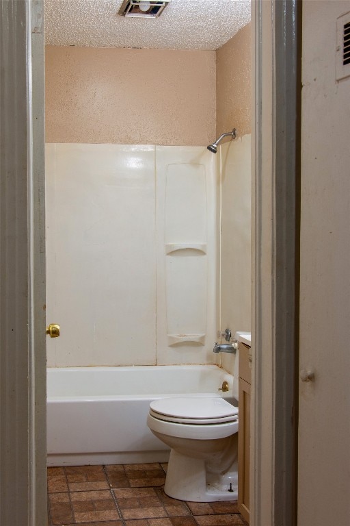 full bathroom featuring vanity, tub / shower combination, tile flooring, a textured ceiling, and toilet