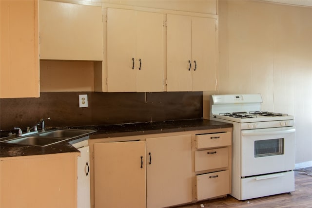 kitchen with white range with gas stovetop, sink, and light hardwood / wood-style flooring