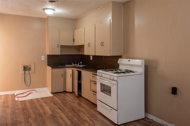 kitchen with white cabinetry, a textured ceiling, white gas range, and dark hardwood / wood-style flooring