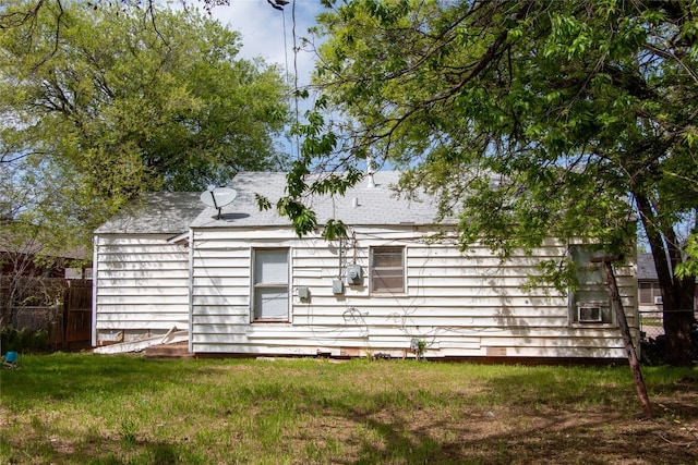 rear view of house with a lawn