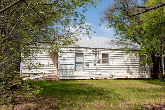 rear view of property with a yard