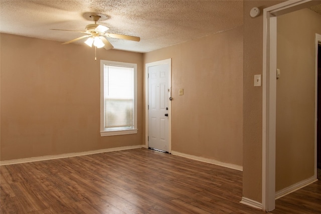 spare room featuring ceiling fan, a textured ceiling, and dark hardwood / wood-style floors