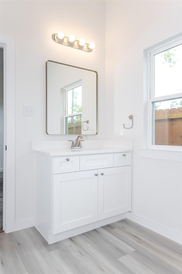 bathroom featuring hardwood / wood-style flooring and vanity