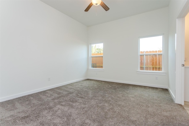 carpeted spare room featuring ceiling fan