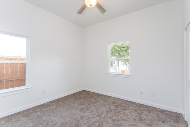 carpeted spare room with ceiling fan