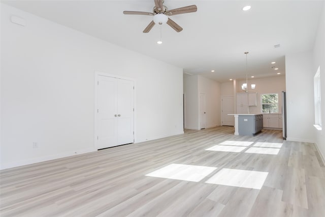 unfurnished living room with light hardwood / wood-style floors and ceiling fan