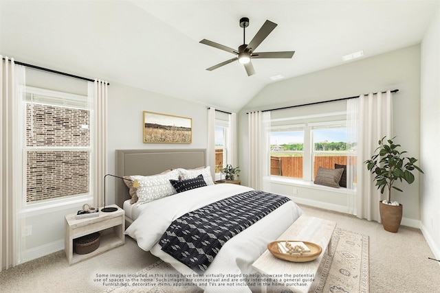 carpeted bedroom featuring ceiling fan and vaulted ceiling