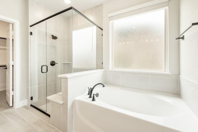 bathroom with separate shower and tub