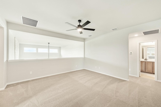 carpeted spare room with ceiling fan