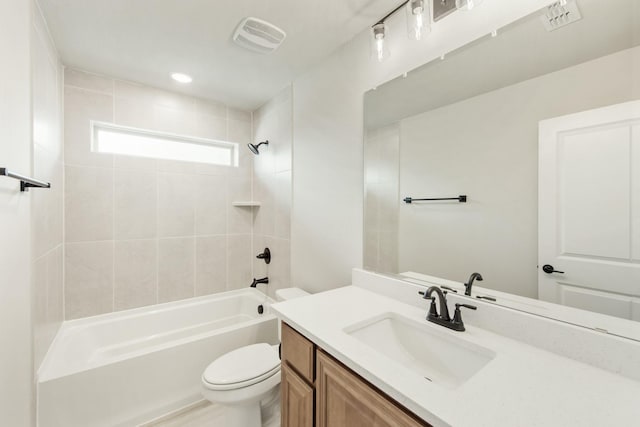 full bathroom with vanity, toilet, and tiled shower / bath