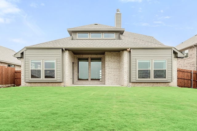 rear view of house featuring a lawn