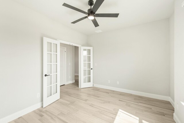 unfurnished room featuring french doors, light hardwood / wood-style floors, and ceiling fan