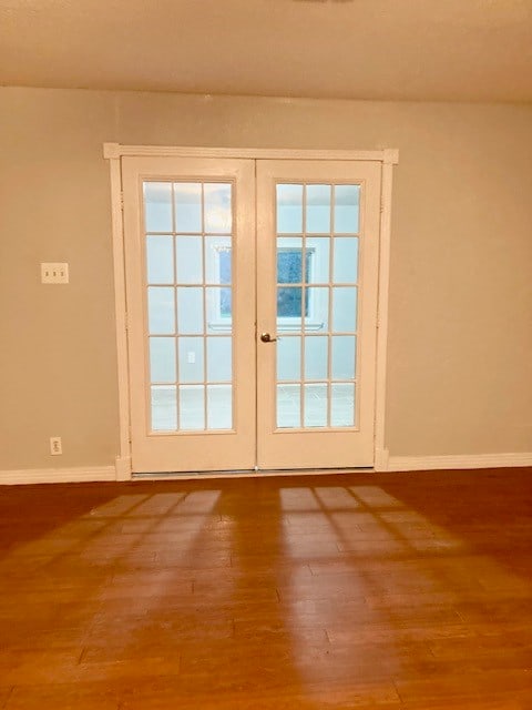 entryway featuring hardwood / wood-style flooring and french doors