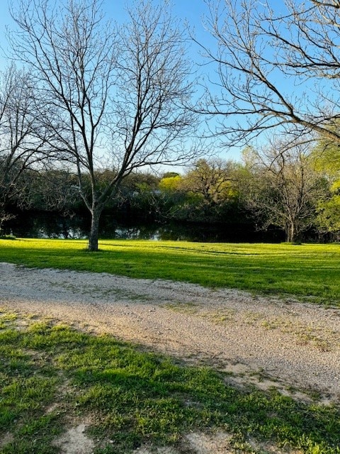 view of home's community featuring a water view and a yard