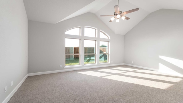 carpeted spare room featuring ceiling fan and high vaulted ceiling