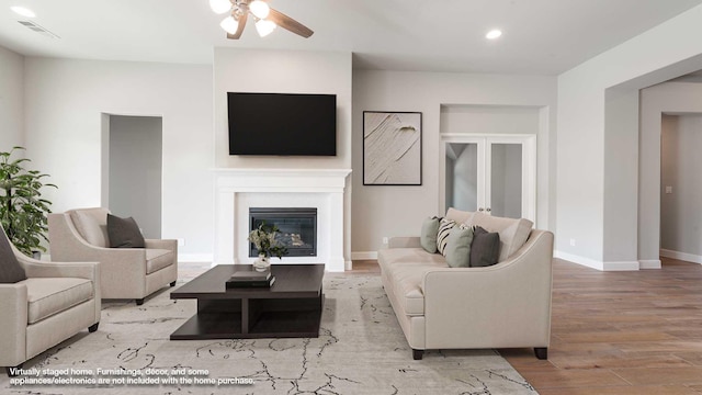 living room with ceiling fan and light wood-type flooring