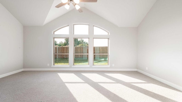 carpeted empty room with ceiling fan and vaulted ceiling