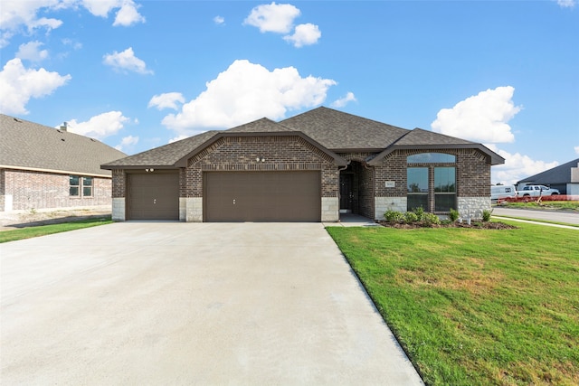 view of front of home featuring a garage and a front lawn