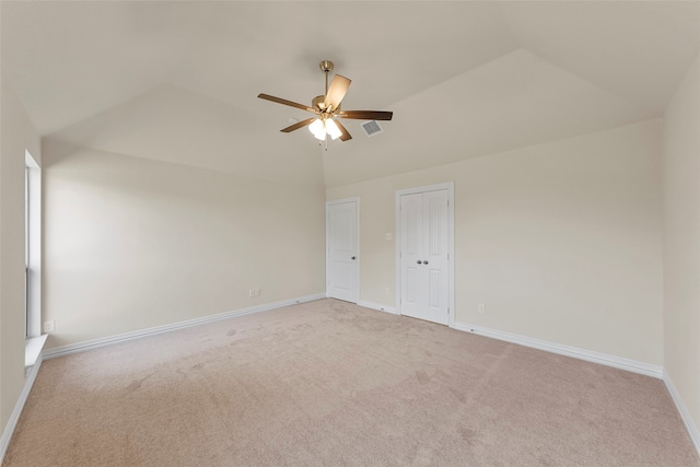 unfurnished room with ceiling fan, light colored carpet, and lofted ceiling