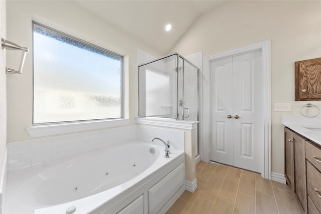 bathroom featuring tile patterned flooring, vanity, vaulted ceiling, and independent shower and bath