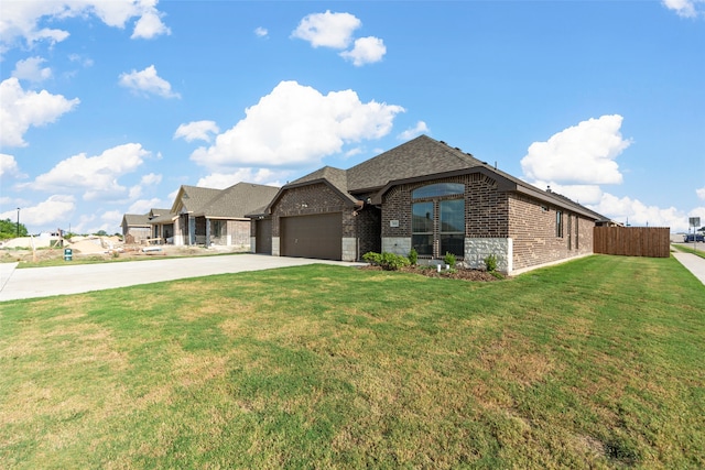 view of front of property with a front yard and a garage