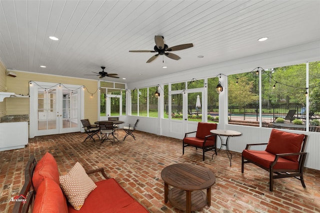 sunroom / solarium with ceiling fan, french doors, and wooden ceiling