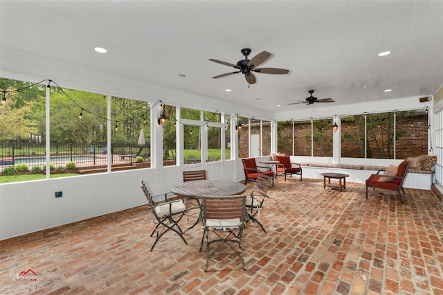 sunroom featuring ceiling fan