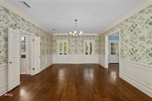 unfurnished dining area with an inviting chandelier, a healthy amount of sunlight, crown molding, and dark hardwood / wood-style floors