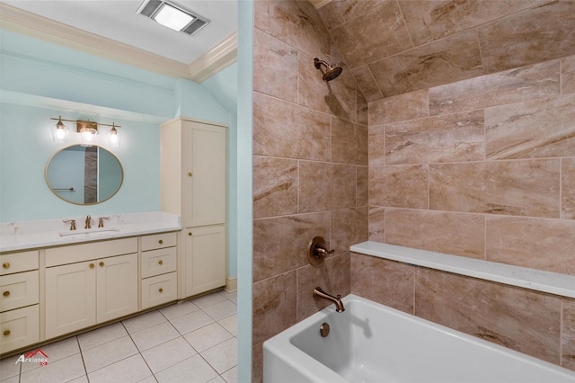 bathroom featuring tile patterned flooring, crown molding, vanity, and tiled shower / bath